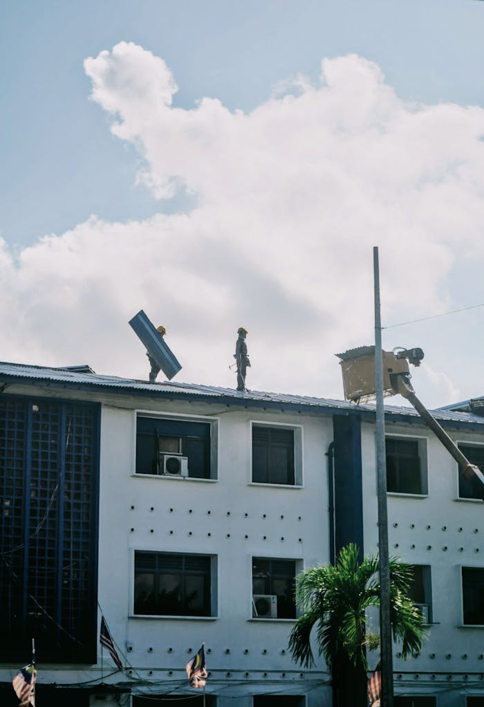 The Art of Drawing Readers In: Your attractive post title goes here Construction workers on a building rooftop in Malaysia under a sunny sky, highlighting urban development.